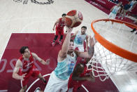 Slovenia's Luka Doncic (77) drives to the basket against Japan's Rui Hachimura, right, during a men's basketball game at the 2020 Summer Olympics, Thursday, July 29, 2021, in Saitama, Japan. (AP Photo/Eric Gay)