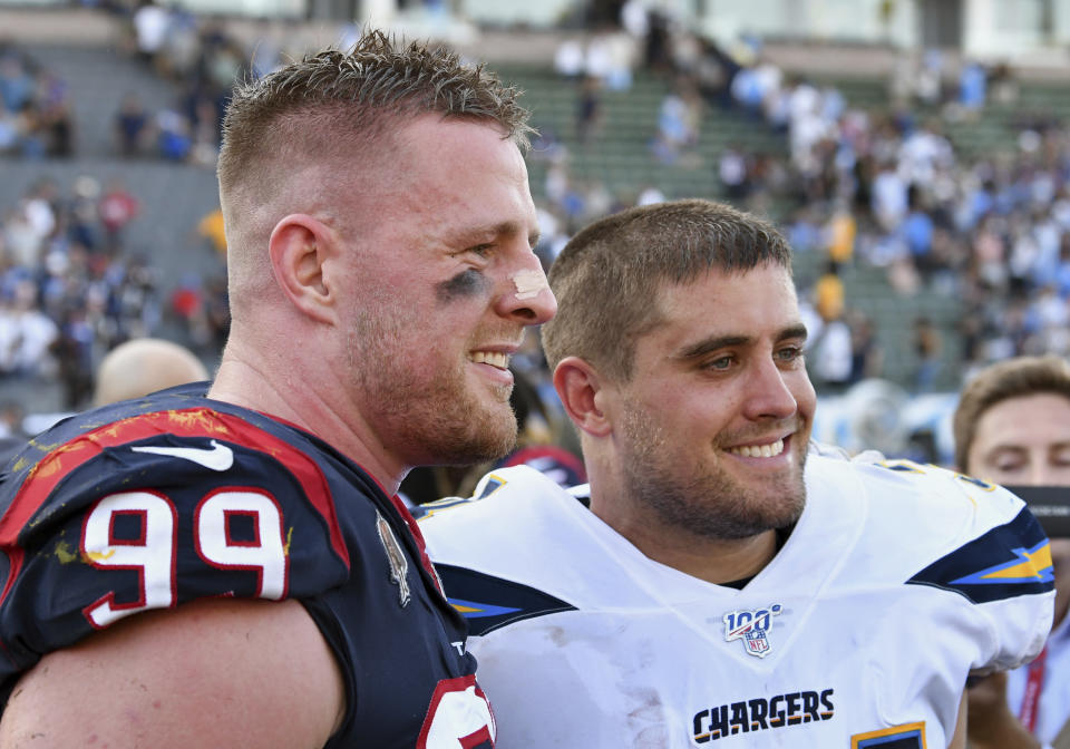 FILE - In this Sept. 22, 2019 file photo, Houston Texans defensive end J.J. Watt (99) stands on the field next to his brother San Diego Chargers fullback Derek Watt (34) after the Texans defeated the Los Angeles Chargers 27 to 20 in an NFL game in Carson, Calif. The three Watt brothers will share the field for the first time ever on Sunday, Sept. 27, 2020, when J.J. Watt and the Texans visit T.J., Derek and the Pittsburgh Steelers. (AP Photo/John Cordes, File)