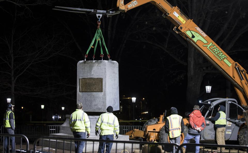 The first and largest piece of the remnants of a Confederate statue known as "Silent Sam" is lifted before being transported to the bed of a truck early Tuesday, Jan. 15, 2019 on the campus of the University of North Carolina in Chapel Hill, N.C. The last remnants of the statue were removed at the request of UNC-Chapel Hill Chancellor Carol Folt, who also announced her resignation in a move that increases pressure on the system's board of governors to give up on plans to restore the monument. (Julia Wall/The News & Observer via AP)
