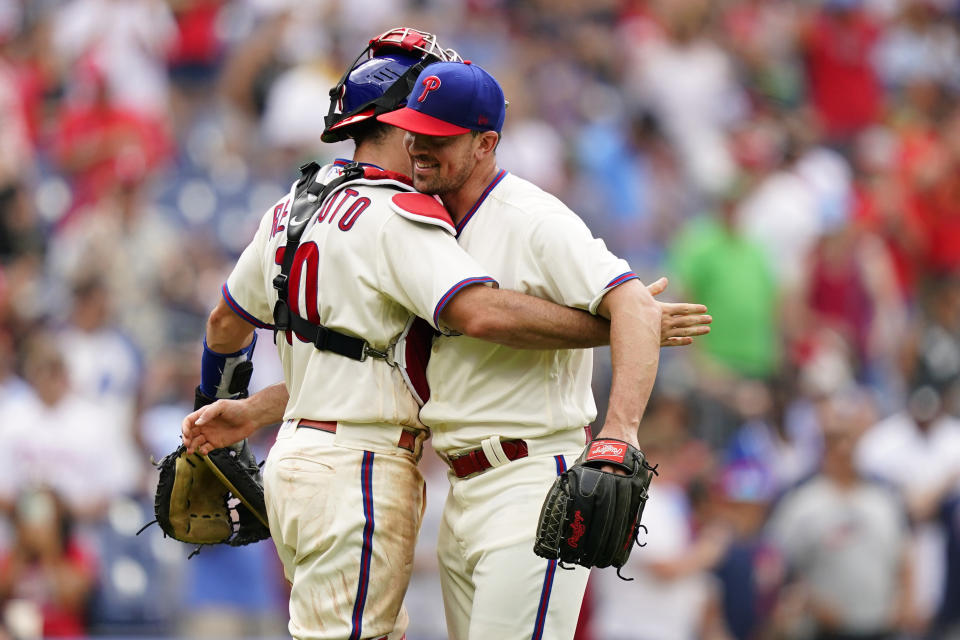 Philadelphia Phillies pitcher Andrew Bellatti, right, and catcher J.T. Realmuto celebrate after a baseball game against the Atlanta Braves, Wednesday, July 27, 2022, in Philadelphia. (AP Photo/Matt Slocum)