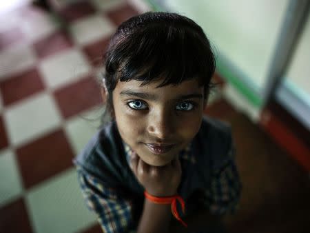 A girl who suffers from hearing and speech disorders reacts to the camera at a rehabilitation centre supported by Bhopal Medical Appeal, for children who were born with mental and physical disabilities, in Bhopal November 11, 2014. REUTERS/Danish Siddiqui