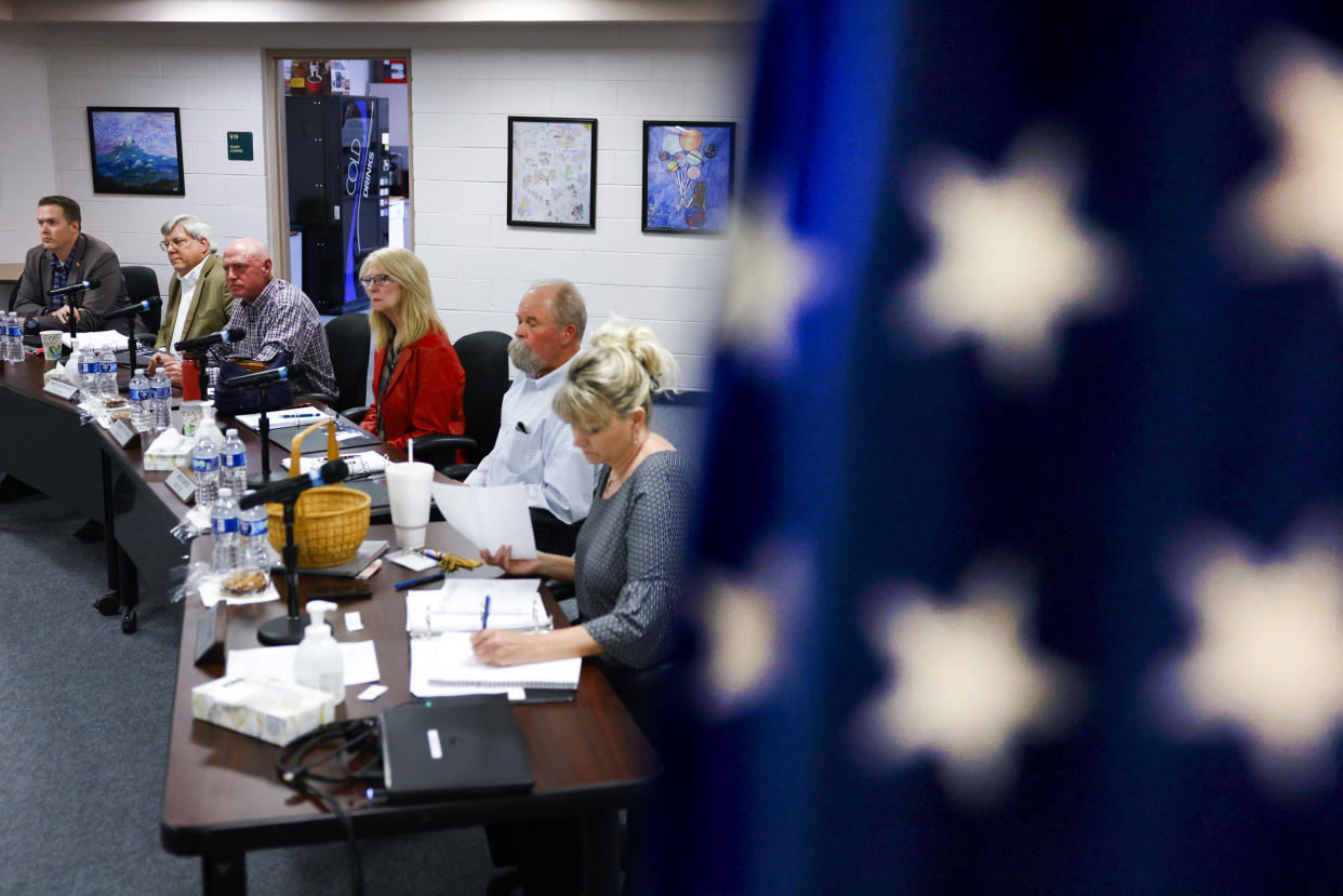 Members of the Woodland Park School District Board of Education listen to public comment during their meeting on April 12, 2023 in Woodland Park, Colo. (Michael Ciaglo for NBC News)