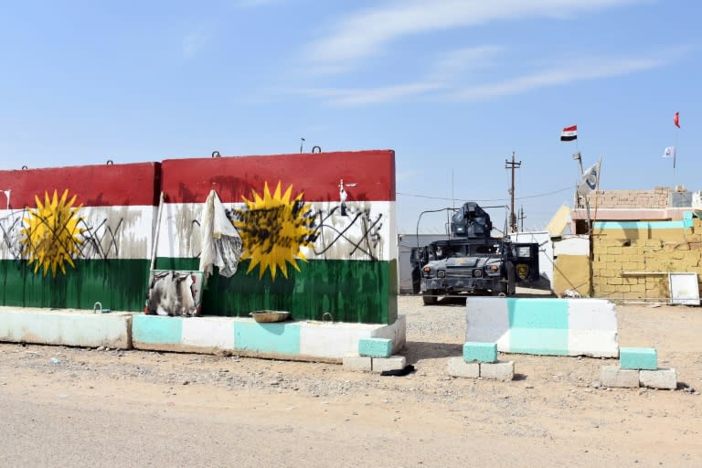 An Iraqi general said federal troops retook "Base 102" west of Kirkuk after peshmerga forces withdrew during the night without a fight