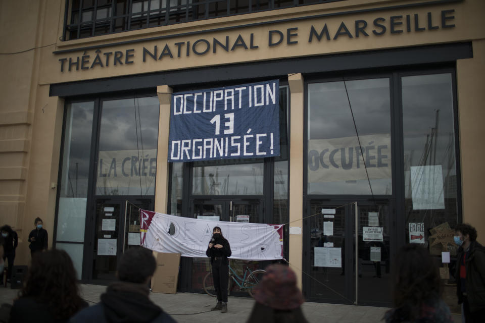 Culture workers, actors, students, and theater employees attend a general assembly at the occupied Theatre de La Criee in Marseille, southern France, Friday, March 25, 2021. Out-of-work French culture and tourism workers are occupying theaters accross France to demand more government support after a year of pandemic that has devastated their incomes and put their livelihoods on indefinite hold. (AP Photo/Daniel Cole)
