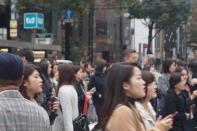 <p>Shoppers and other pedestrians stroll through Tokyo’s fashionable Ginza district, which has many upscale stores and restaurants. (Photo: Michael Walsh/Yahoo News) </p>