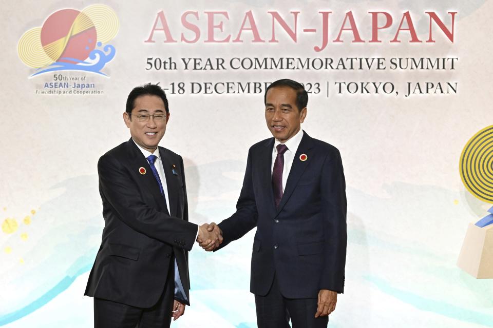 Japan's Prime Minister Fumio Kishida, left, greets Indonesia's President Joko Widodo upon arrival for the opening session of ASEAN-Japan Commemorative Summit Meeting at the Hotel Okura Tokyo in Tokyo Sunday, Dec. 17, 2023. (Kazuhiro Nogi/Pool Photo via AP)