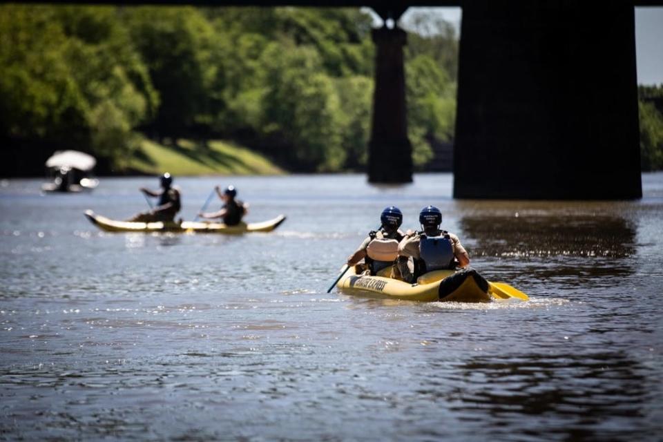 US Army soldiers paddle their kayaks down the Chattahoochee River.