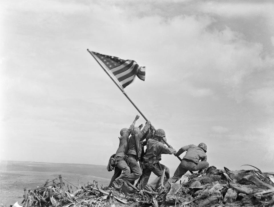 FILE - U.S. Marines of the 28th Regiment, 5th Division, raise a U.S. flag atop Mount Suribachi, Iwo Jima, Japan, Feb. 23, 1945. In 1928, two members of the Gila Indian River Community sued county election officials after being turned away from the polls, only to have the Arizona Supreme Court rebuff their case. The community wouldn't realize the right to vote until 1948 — after World War II and the raising of an American flag at Iwo Jima that included Ira Hayes, who was part of the Gila River community. (AP Photo/Joe Rosenthal, File)