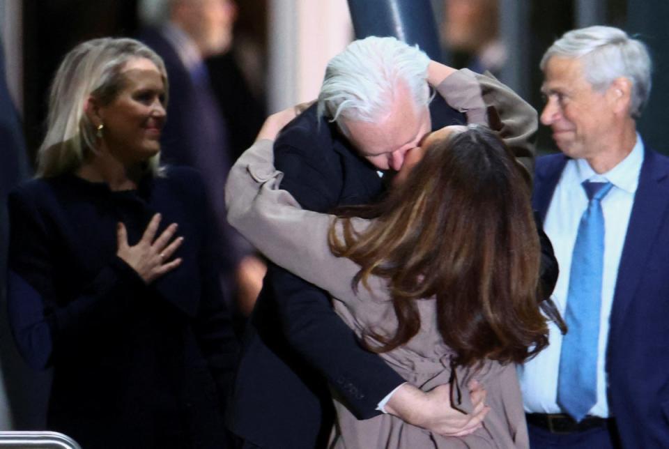 Julian Assange kisses his wife Stella Assange as he arrives in Canberra, Australia (REUTERS)