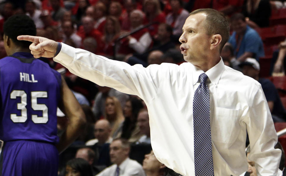 Weber State head coach Randy Rahe directs his players during the first half of a second-round game in the NCAA college basketball tournament against Arizona Friday, March 21, 2014, in San Diego. (AP Photo/Gregory Bull)