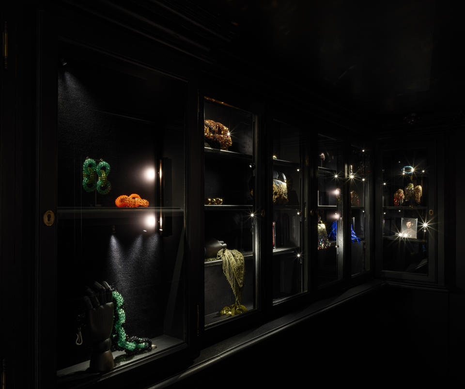 Jewelry, scarves and other fashion items are displayed in dark cabinets.