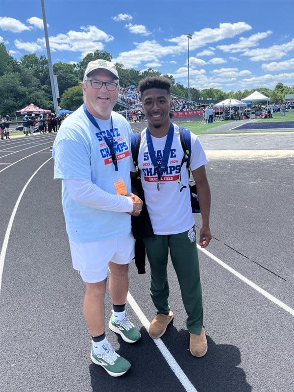 Austin McGee (right) with his gold medal after the GHSA Class 2A track and field state championships.