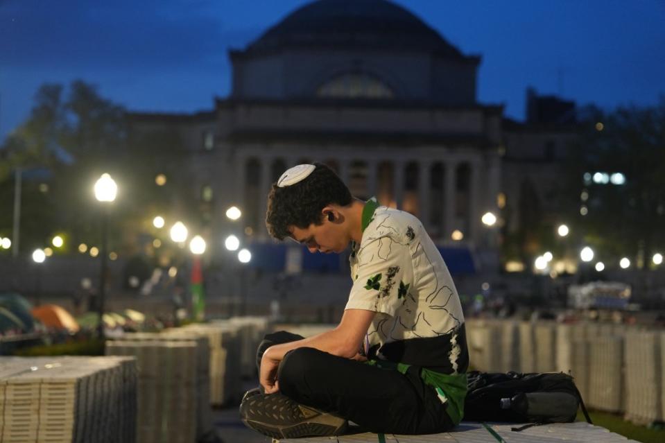 A Columbia University who said he was Jewish, sits near anti-Israel encampment on the lawn of the university’s campus on April 29, 2024. James Keivom