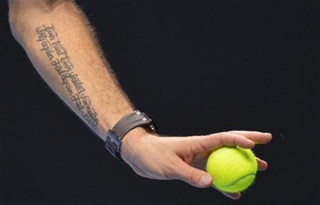 A tattoo reading 'Ever tried. Ever failed. No matter. Try again. Fail again. Fail better.' is seen on the arm of Stanislas Wawrinka of Switzerland as he serves during his ATP World Tour Finals men's singles tennis match against Tomas Berdych of the Czech Republic at the O2 Arena in London, November 4, 2013. REUTERS/Toby Melville