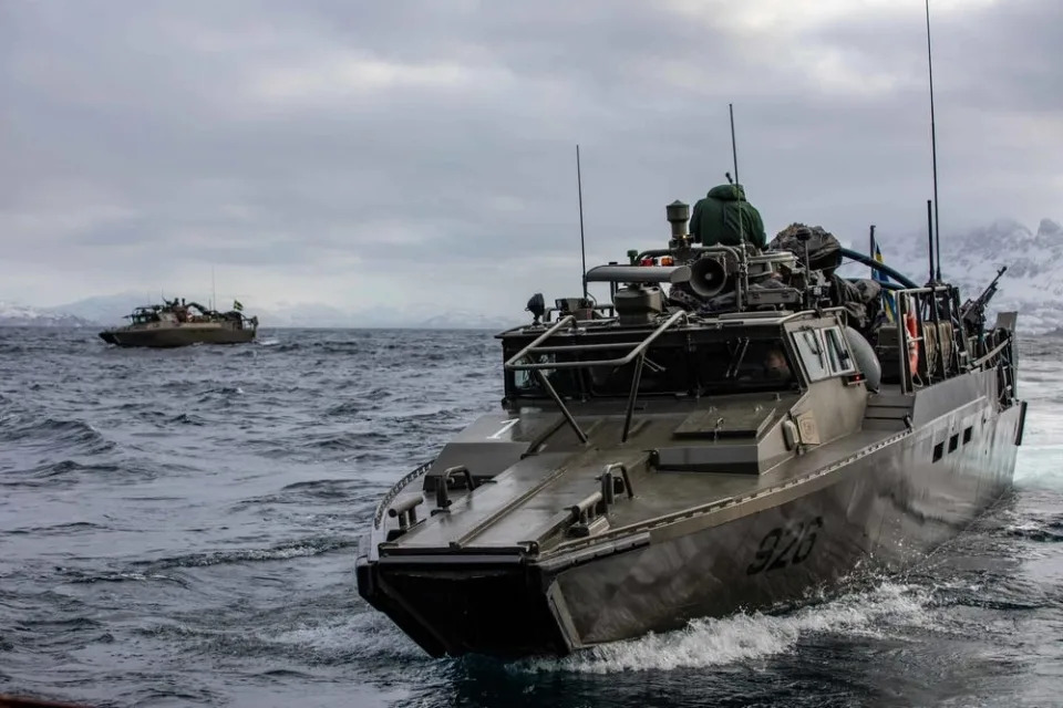 A Swedish CB90 fast assault craft in the water, with another CB90 in the distance.