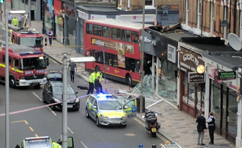 The scene after the bus left the road and hit a shop