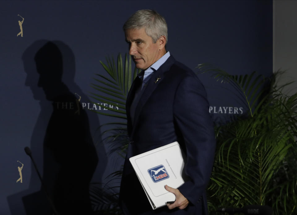 FILE- In this March 13, 2020 file photo, PGA Tour Commission Jay Monahan attends a news conference in Ponte Vedra Beach, Fla. This week marks a year since Monahan announced the tour would shut down because of the COVID-19 pandemic. (AP Photo/Chris O'Meara, File)