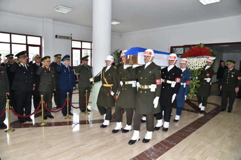 A picture released and taken on November 30, 2015 by Turkish army press office shows Turkish soldiers walking by officials of Russian army as they carry the coffin of Russian pilot Lt. Col. Oleg Peshkov into a Russian Air Force transport