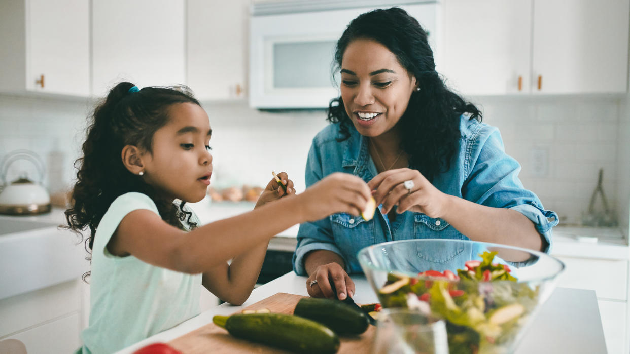 mother and daughter cooking at home