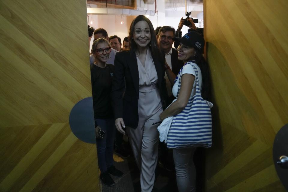 María Corina Machado, a former lawmaker and longtime government foe, smiles as she leaves the room after speaking to the press in Caracas, Venezuela, Tuesday, Oct. 24, 2023. Machado continued to dominate the primary election held to pick the opposition's candidate to challenge Venezuelan President Nicolás Maduro next year, holding her support above 90% in the latest partial returns announced Monday. (AP Photo/Ariana Cubillos)