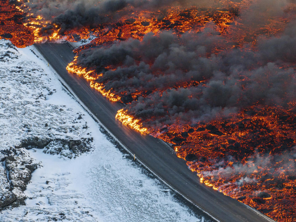 A view of lava crossing the main road to Grindavík and flowing on the road leading to the Blue Lagoon, in Grindavík, Iceland, Thursday, Feb. 8, 2024. A volcano in southwestern Iceland has erupted for the third time since December and sent jets of lava into the sky. The eruption on Thursday morning triggered the evacuation the Blue Lagoon spa which is one of the island nation’s biggest tourist attractions. (AP Photo /Marco Di Marco)