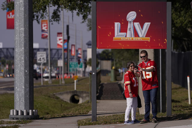 FILE - In this Feb. 4, 2021, file photo, Kansas City Chiefs fans take a selfie outside of Raymond James Stadium ahead of Super Bowl 55 in Tampa, Fla. The city is hosting Sunday's Super Bowl football game between the Tampa Bay Buccaneers and the Kansas City Chiefs. (AP Photo/Charlie Riedel, File)
