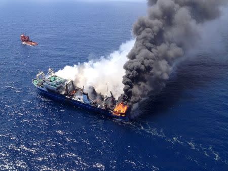 The Oleg Naydenov, a Russian fishing trawler full of fuel, which caught fire over the weekend in Gran Canaria's port of Las Palmas, can be seen in this handout picture taken April 12, 2015. REUTERS/Salvamento Maritimo/Handout via Reuters