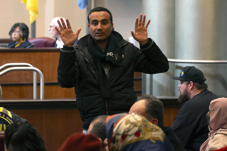 A man urges restraint from members of his group at a special session of City Council to consider a resolution calling for an immediate cease-fire in Gaza, Monday, Nov. 27, 2023, in Oakland, Calif. (AP Photo/D. Ross Cameron)