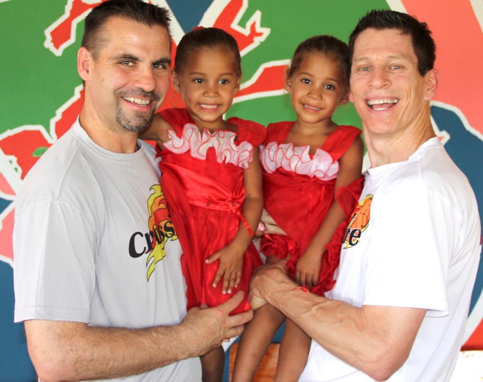 Crossfire's Randy Shepherd, left, and Jamie Johnson pose with two girls during their trip to Nicaragua.