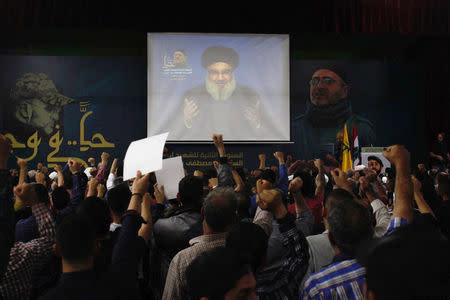 Lebanon's Hezbollah leader Sayyed Hassan Nasrallah is seen on a video screen as he addresses his supporters in Beirut, Lebanon May 14, 2018. REUTERS/Aziz Taher