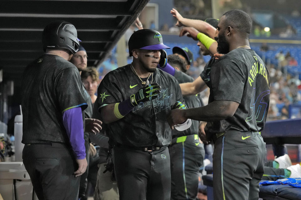 Tampa Bay Rays' Isaac Paredes, center, celebrates his solo home run off Chicago White Sox starting pitcher Michael Soroka with Randy Arozarena, right, during the sixth inning of a baseball game Tuesday, May 7, 2024, in St. Petersburg, Fla. (AP Photo/Chris O'Meara)