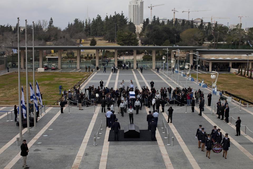 Members of the Knesset guard carry the coffin of former Israeli Prime Minister Ariel Sharon at the Knesset plaza, in Jerusalem, Sunday, Jan. 12, 2014. Sharon, the hard-charging Israeli general and prime minister who was admired and hated for his battlefield exploits and ambitions to reshape the Middle East, died Saturday, eight years after a stroke left him in a coma from which he never awoke. He was 85. (AP Photo/Oded Balilty)