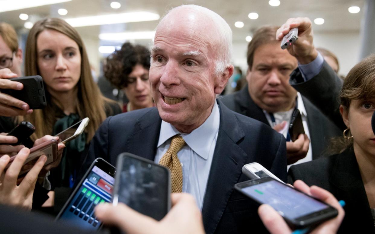 Republican Senator from Arizona John McCain (C) speaks to members of the news media at the Senate subway before a procedural vote to advance debate on tax reform, on Capitol Hill in Washington, DC, USA, 17 October 2017 - EPA