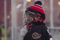 <p>Former Ottawa Senators goaltender Pascal Leclaire rocks the classic Jose Theodore-inspired, toque-over-the-helmet look during Friday’s alumni game. </p>