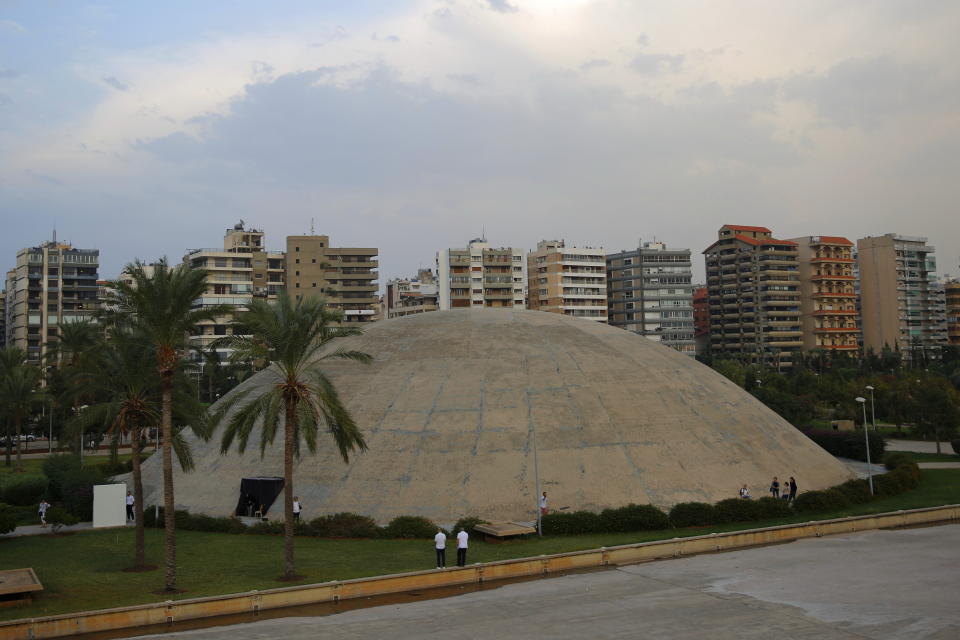 FILE - Visitors tour The Experimental Theater, designed in the early 1960s by the late Brazilian architect Oscar Niemeyer, at the Rashid Karami International Fair, in the northern city of Tripoli, Lebanon, on Oct. 20, 2018. UNESCO on Wednesday Jan. 25, 2023 added one of Yemen's ancient kingdoms and a Lebanese modernist concrete fair park to its list of World Heritage sites in danger, the latest entries from The Middle East. (AP Photo/Hassan Ammar, File)