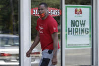 A man walks past Marco's Pizza, which is now hiring, Friday, June 5, 2020, in Euclid, Ohio. U.S. unemployment dropped unexpectedly in May to 13.3% as reopened businesses began recalling millions of workers faster than economists had predicted, triggering a rally Friday on Wall Street. (AP Photo/Tony Dejak)