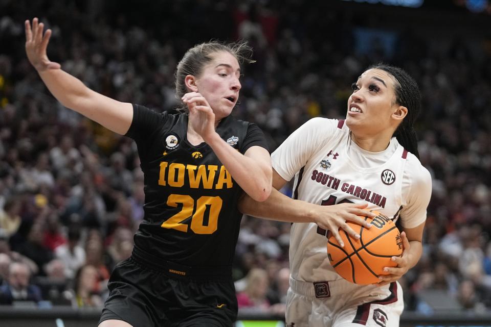 South Carolina's Brea Beal tries to drive by Iowa's Kate Martin during the second half of an NCAA Women's Final Four semifinals basketball game Friday, March 31, 2023, in Dallas. (AP Photo/Darron Cummings)