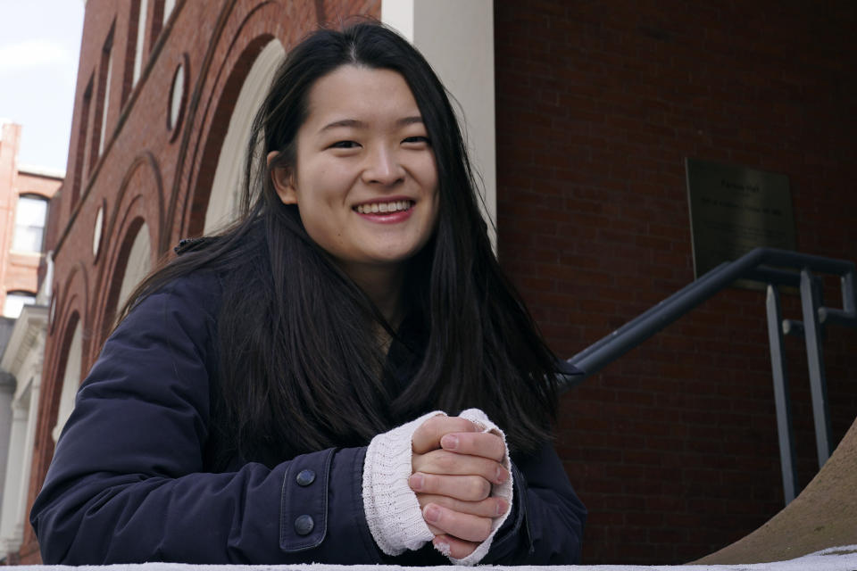 Julia Riew poses outside Farkus Hall, on the campus of Harvard University in Cambridge, Mass., Wednesday, Feb. 16, 2022. Obsessed with strong female animated characters, Korean American college student Riew didn't see any who looked like her, so she's designed her own. Riew, a Harvard senior, wrote a full-length musical as her thesis, played the part of Princess Shimcheong, and has been performing her songs on TikTok, drawing a huge following and sparking interest from filmmakers and theater producers. (AP Photo/Charles Krupa)