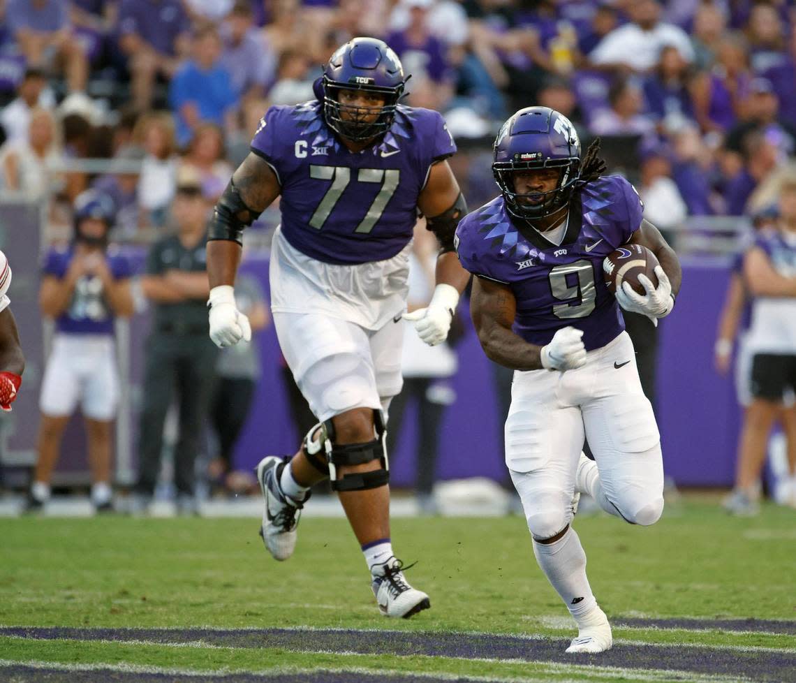 TCU running back Emani Bailey (9) leads offensive lineman Brandon Coleman (77) down field for a long gain on Sept. 09, 2023.