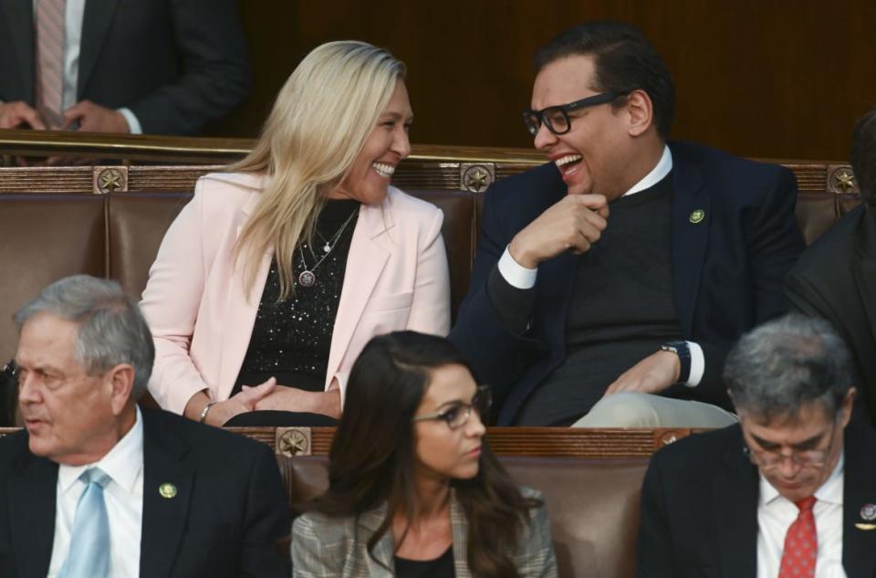 <div class="inline-image__caption"><p>Rep. Marjorie Taylor Greene laughs with Rep.-elect George Santos during a meeting of the 118th Congress.</p></div> <div class="inline-image__credit">Matt McClain/The Washington Post via Getty</div>