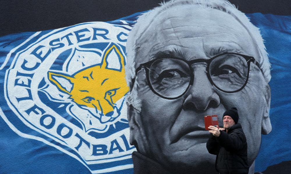 A man takes a picture in front of a mural of Claudio Ranieri in Leicester city centre.