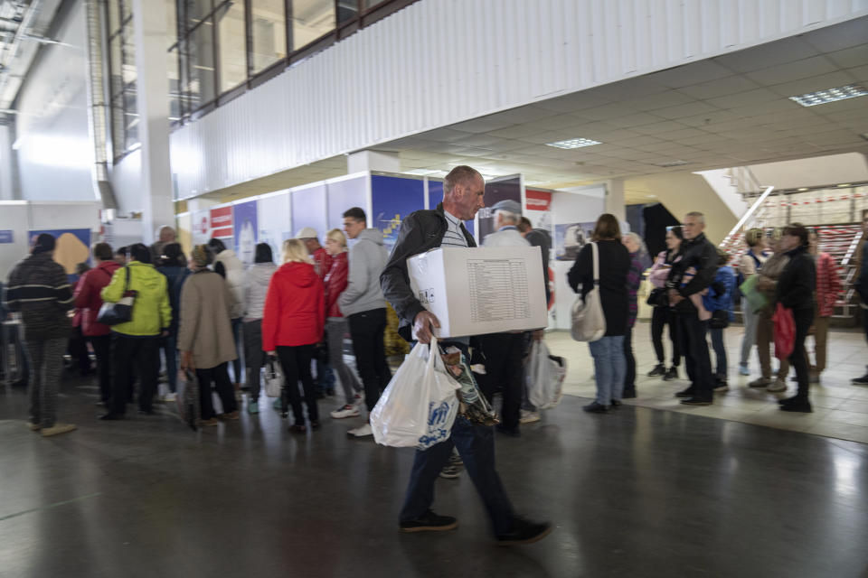 People receive humanitarian aid at the distribution center for displaced people in Zaporizhia, Ukraine, Thursday, May 5, 2022. (AP Photo/Evgeniy Maloletka)