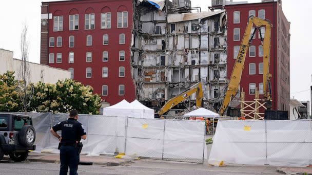 PHOTO: A police officer stands at the site of a collapsed apartment building, June 5, 2023, in Davenport, Iowa. (Charlie Neibergall/AP, FILE)