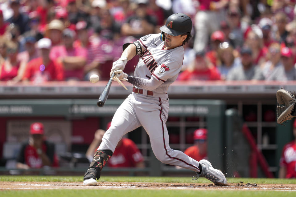 Arizona Diamondbacks' Corbin Carroll hits a single against the Cincinnati Reds during the first inning of a baseball game, Sunday, July 23, 2023, in Cincinnati. (AP Photo/Jeff Dean)