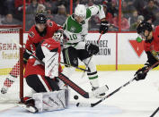 Ottawa Senators goaltender Craig Anderson (41) and defenseman Mike Reilly (5) keep the puck from Dallas Stars right wing Corey Perry (10) during the second period of an NHL hockey game Sunday, Feb. 16, 2020, in Ottawa, Ontario. (Justin Tang/The Canadian Press via AP)