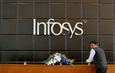 An employee of Infosys stands at the front desk of its headquarters in Bengaluru, India, April 15, 2016. REUTERS/Abhishek N. Chinnappa