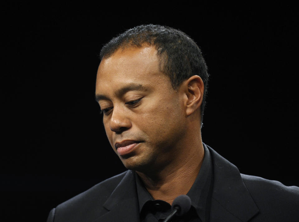 FILE - In this March 24, 2014 file photo, Tiger Woods looks down during a news conference at the Newseum in Washington. Woods says his recovery from back surgery is going slowly and he's not sure when he'll be able to return to golf. In a wide-ranging blog on his website Monday, May 5, 2014, Woods says he remains sore from the incision during the March 31 operation for a pinched nerve. (AP Photo/Susan Walsh, File)