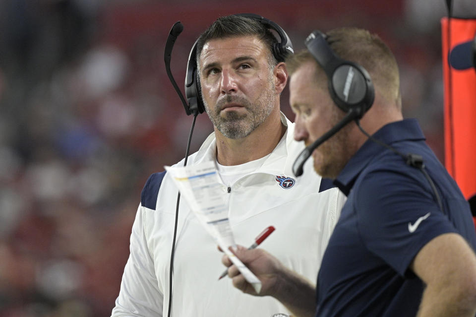 Tennessee Titans head coach Mike Vrabel, left, and offensive coordinator Todd Downing work from the sideline during the first half of a preseason NFL football game against the Tampa Bay Buccaneers, Saturday, Aug. 21, 2021, in Tampa, Fla. (AP Photo/Phelan M. Ebenhack)