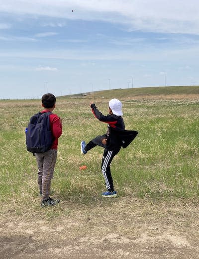 Soil Campers throwing native plant seed balls onto the land. (Author provided)