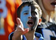 A young Carolina Panthers fan yells from the stands before the NFL's Super Bowl 50 football game between the Panthers and the Denver Broncos in Santa Clara, California February 7, 2016. REUTERS/Mike Blake